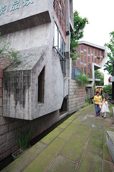 A narrow street in China showing modern roof structure